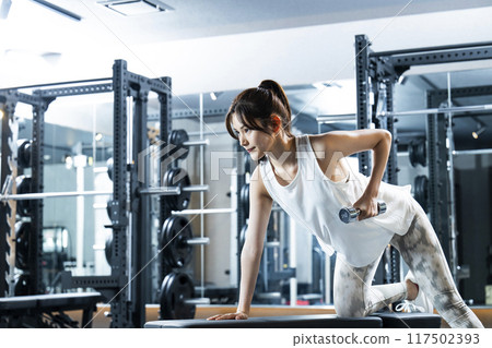 Young woman training in a sports gym Young woman training in a sports gym 117502393