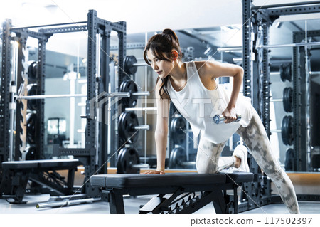 Young woman training in a sports gym 117502397