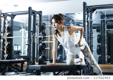 Young woman training in a sports gym Young woman training in a sports gym 117502403