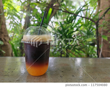 iced americano coffee mixed with orange juice on plastic cup 117504080