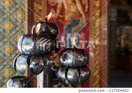 Oil lamp light in Buddhist temple at Wat Khoi, Phetchaburi 117504082