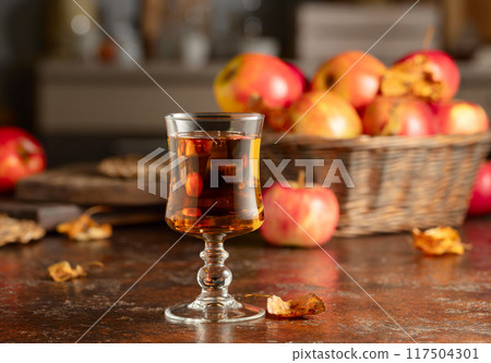 Apple juice on an old kitchen table. Apple juice on an old kitchen table. 117504301
