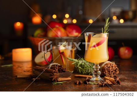 Mulled cider with apples slices, cinnamon, rosemary, and anise. Mulled cider with apples slices, cinnamon, rosemary, and anise. 117504302