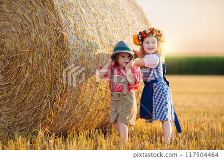 Child in wheat field with German bread Child in wheat field with German bread 117504464