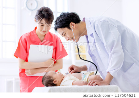 Image of a male doctor examining a baby Image of a male doctor examining a baby 117504621