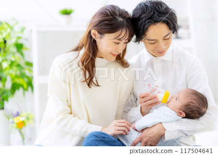 A couple giving milk to their baby 117504641