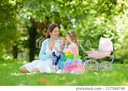 Mother and kids enjoying picnic outdoors 117504746