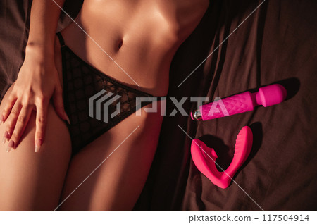 vibrator and vacuum stimulator is lying nearby sexy female body. Girl woman lonely nymphomaniac in underwear is lying on a bed with a set of sex toy at night in bedroom vibrator and vacuum stimulator is lying nearby sexy female body. Girl woman lonely nymphomaniac in underwear is lying on a bed with a set of sex toy at night in bedroom 117504914