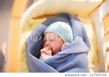 Newborn baby boy in hospital cot Newborn baby boy in hospital cot 117505159