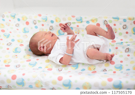 Newborn baby boy in hospital cot Newborn baby boy in hospital cot 117505170