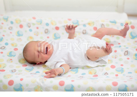 Newborn baby boy in hospital cot 117505171