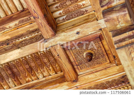 Decorative drawings carved on the wooden ceiling. Wood carving, carpentry, manual labor, preservation of cultural traditions, skills, craftsmanship. Apprenticeship Training 117506061