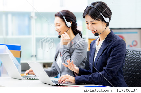 Young female operator working in a call center 117506134