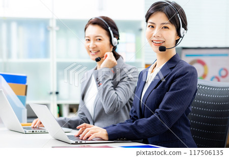 Young female operator working in a call center 117506135
