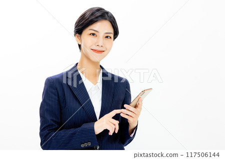 Woman operating a smartphone 117506144