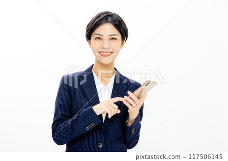 Woman operating a smartphone 117506145