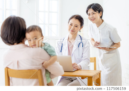 Doctor and family examining a baby Doctor and family examining a baby 117506159