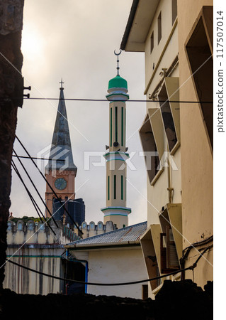 Christian church and minaret of the mosque side by side in Stone Town, Zanzibar, Tanzania Christian church and minaret of the mosque side by side in Stone Town, Zanzibar, Tanzania 117507014