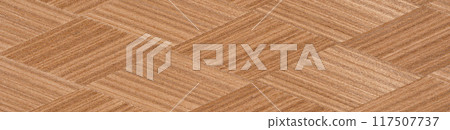 Intricate chevron pattern in natural wood veneer with rich brown hues 117507737