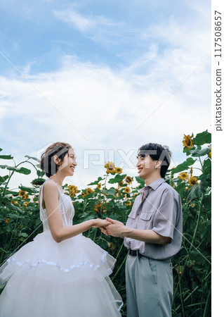 Couple dancing in a sunflower field Couple dancing in a sunflower field 117508657