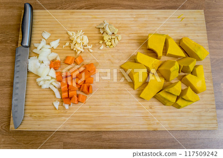 Cutting board with ingredients for preparing pumpkin porridge with tofu and vegetables Cutting board with ingredients for preparing pumpkin porridge with tofu and vegetables 117509242