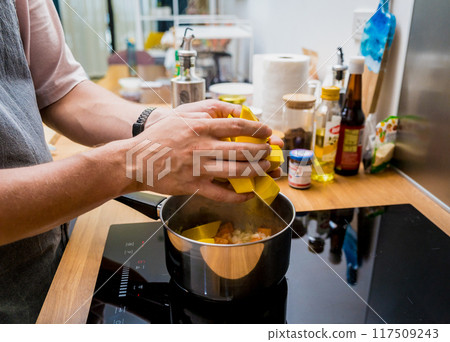 Chef at the kitchen preparing pumpkin porridge with tofu and vegetables 117509243