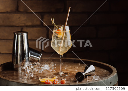 Elegant cocktail with citrus garnish in a wine glass, perfect for upscale dining and bar promotions Elegant cocktail with citrus garnish in a wine glass, perfect for upscale dining and bar promotions 117509609