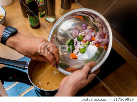 Chef at the kitchen preparing massaman curry with sweet potato and many spices Chef at the kitchen preparing massaman curry with sweet potato and many spices 117509989