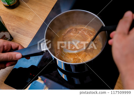Chef at the kitchen preparing massaman curry with sweet potato and many spices 117509999