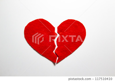 Broken red heart made of felt. Broken love concept.  A broken heart isolated on a white background. A  pain in my heart 117510410