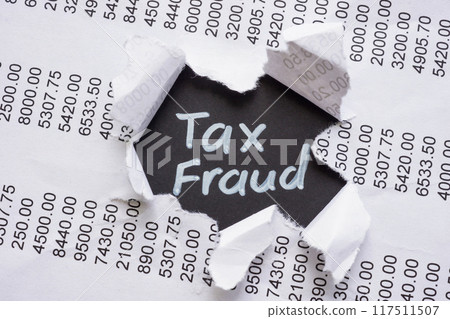 Torn financial report with the words Tax Fraud. Financial deception concept. Torn financial report with the words Tax Fraud. Financial deception concept. 117511507