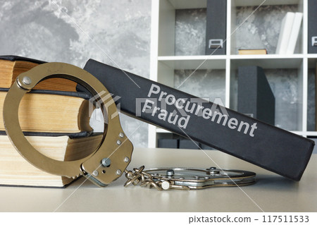 Books about procurement fraud and handcuffs. Legal consequences concept. Books about procurement fraud and handcuffs. Legal consequences concept. 117511533