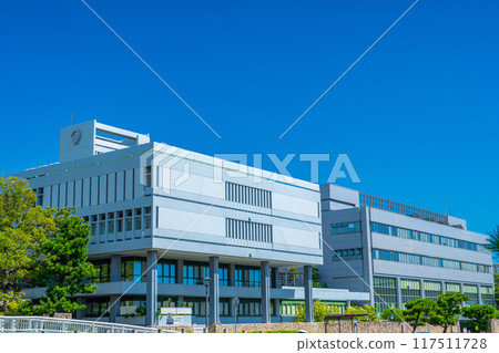 Ashiya City Hall building shining against the blue midsummer sky in Ashiya City, Hyogo Prefecture 117511728