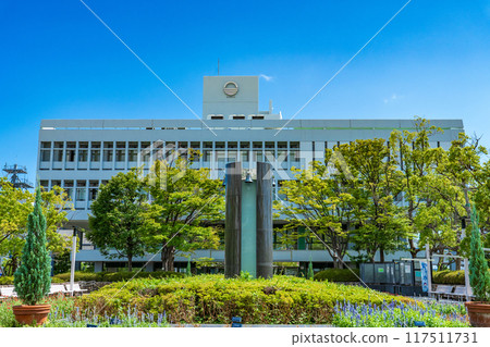 Ashiya City Hall building shining against the blue midsummer sky in Ashiya City, Hyogo Prefecture 117511731