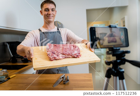 The chef is broadcasting live from workshop how to prepare a beef steaks on the electric grill The chef is broadcasting live from workshop how to prepare a beef steaks on the electric grill 117512236