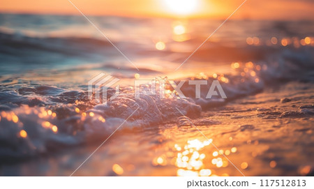 Ocean wave close-up gentle illuminated warm golden setting sun beach 117512813