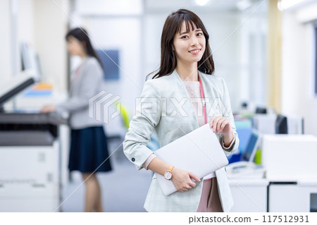 Woman with laptop in the office Woman with laptop in the office 117512931