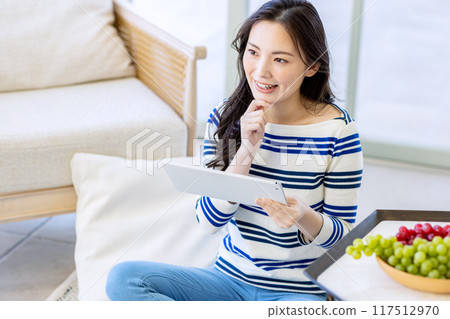 Young woman looking at a smartphone Young woman looking at a smartphone 117512970