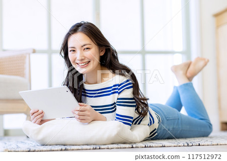 Young woman living alone 117512972