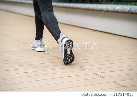 Exercise feet in running shoes 117514035