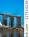 A stunning view of Sands Sky Park atop Marina Bay Sands in Singapore, captured during twilight. The deep blue sky at dusk creates a romantic and beautiful backdrop. 117514230