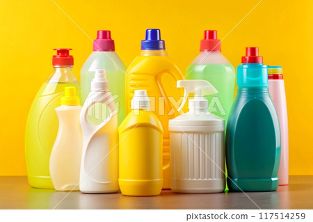 Plastic various bottles for detergents on yellow background 117514259