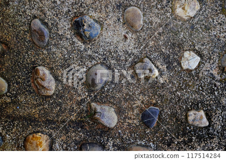 Dirty rustic and vintage grunge concrete wall. Stone and cement wall, embedded stone decorate texture on surface wall background Dirty rustic and vintage grunge concrete wall. Stone and cement wall, embedded stone decorate texture on surface wall background 117514284