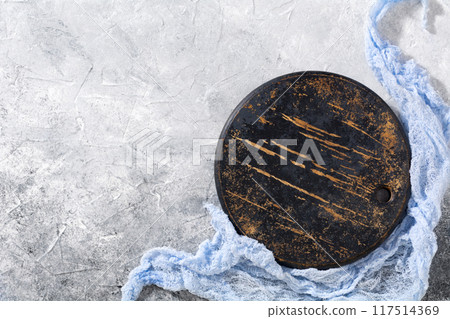 Old wooden cutting board on grey background. Top view. Copy space. 117514369