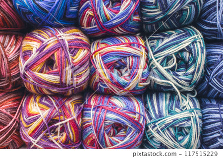 Colourful ball of yarn in storage. Warm wool yarn in vibrant colors. Knitting hobby. Row of vivid yarn. Handiwork store. Knit background. Handcraft concept. Knit pattern. 117515229