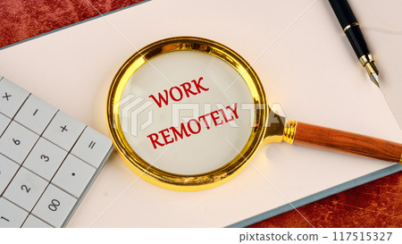 Networking, communication and person on computer for planning, online discussion. WORK REMOTELY written through a magnifying glass in red letters in a notebook on a blank sheet Networking, communication and person on computer for planning, online discussion. WORK REMOTELY written through a magnifying glass in red letters in a notebook on a blank sheet 117515327