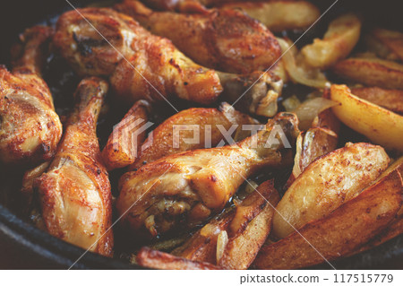 fried chicken drumsticks with potato slices, in a clay pan, baked in the oven, with spices, homemade, no people, 117515779