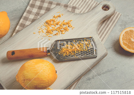 Grated lemon zest, on a cutting board, with a grater , top view, no people, Grated lemon zest, on a cutting board, with a grater , top view, no people, 117515818