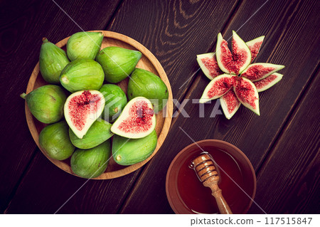 Fresh green figs, top view, on a wooden table, 117515847