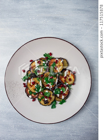 Fried eggplant, with white sauce, pomegranate seeds, top view, no people, Fried eggplant, with white sauce, pomegranate seeds, top view, no people, 117515878